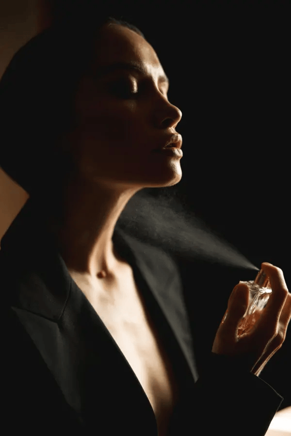 women putting luxora perfume